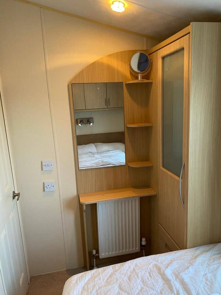 Single wardrobe by shelves with mirror and central heating