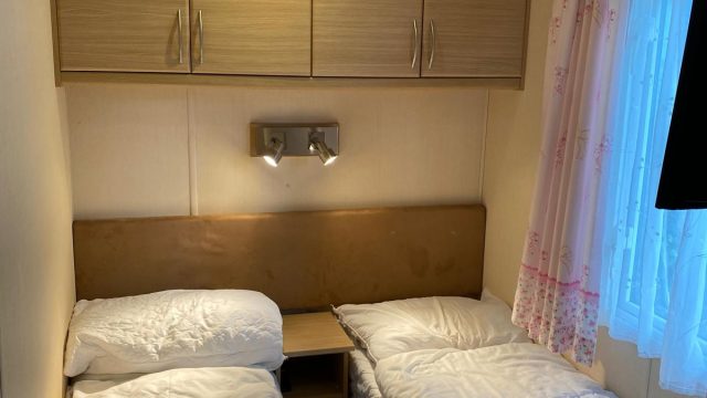 2 single beds with over head storage and window