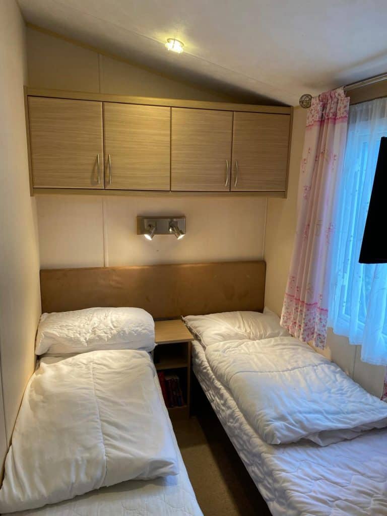 2 single beds with over head storage and window