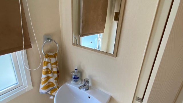 white hand basin with mirror on wall