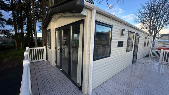 static caravan with patio doors and decking